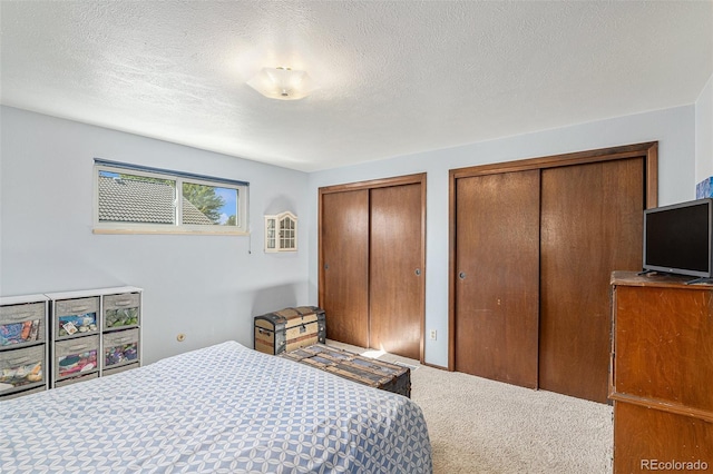 7622 E Nassau Ave, Denver, CO 80237 - carpeted bedroom with multiple closets and a textured ceiling