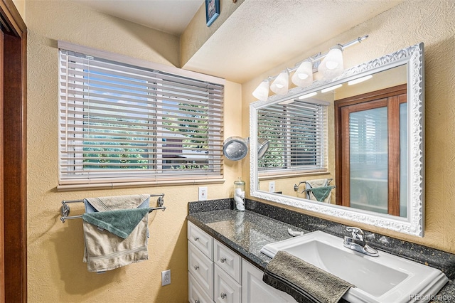 7622 E Nassau Ave, Denver, CO 80237 - bathroom featuring vanity and a textured wall