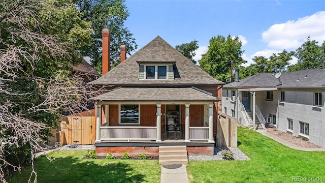 459 N Clarkson St, Denver, CO 80218 - view of front facade featuring roof with shingles, a porch, brick siding, and a chimney