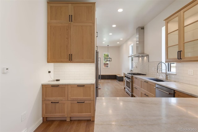 459 N Clarkson St, Denver, CO 80218 - kitchen with wall chimney range hood, appliances with stainless steel finishes, light wood-style flooring, light stone countertops, and recessed lighting