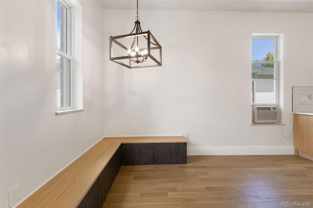459 N Clarkson St, Denver, CO 80218 - unfurnished dining area with a chandelier, light wood finished floors, and cooling unit