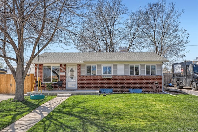 3180 Mowry Pl, Westminster, CO 80031 - view of front facade featuring fence, a front lawn, and brick siding