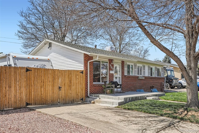 3180 Mowry Pl, Westminster, CO 80031 - view of front of house with brick siding, fence, and a shingled roof