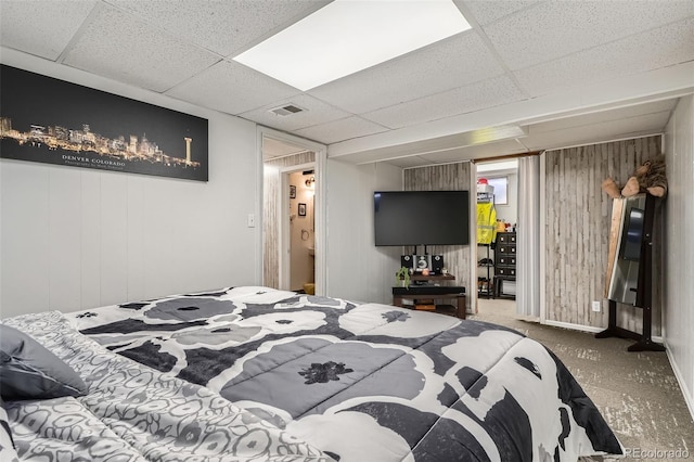 3180 Mowry Pl, Westminster, CO 80031 - carpeted bedroom with wood walls, a drop ceiling, and visible vents