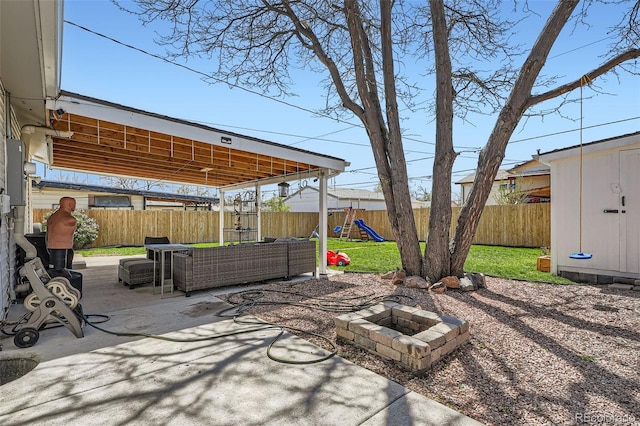3180 Mowry Pl, Westminster, CO 80031 - view of patio with a fenced backyard, an outdoor living space with a fire pit, and a playground