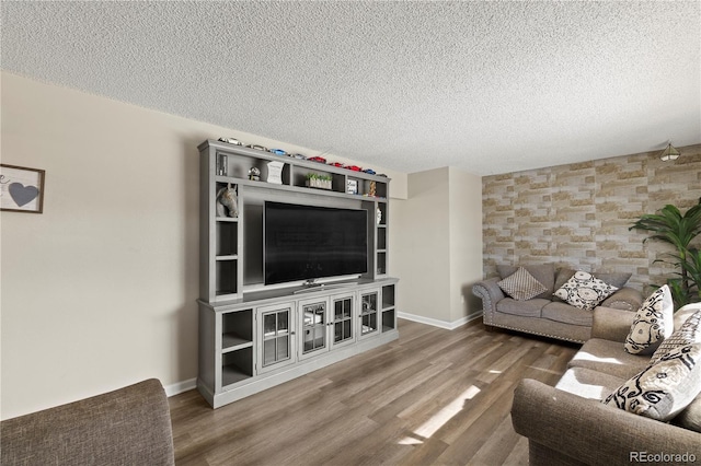 living room featuring hardwood / wood-style floors and a textured ceiling