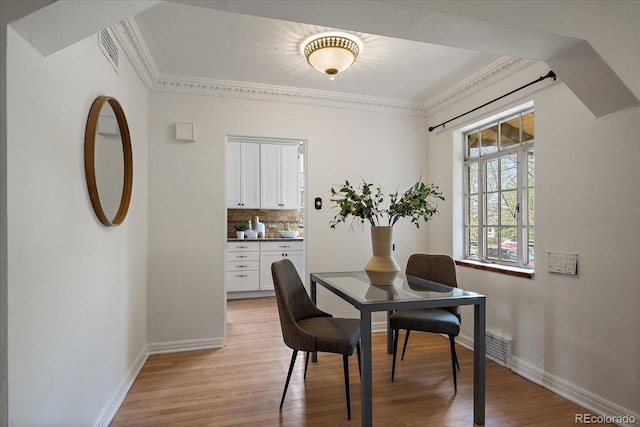 1439 Dexter St, Denver, CO 80220 - dining space featuring light wood finished floors, baseboards, and ornamental molding