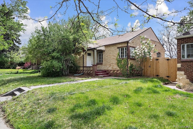1439 Dexter St, Denver, CO 80220 - view of front of house featuring brick siding and roof with shingles