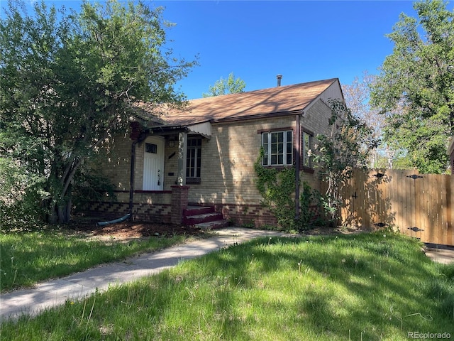 1439 Dexter St, Denver, CO 80220 - view of front of home with fence and brick siding