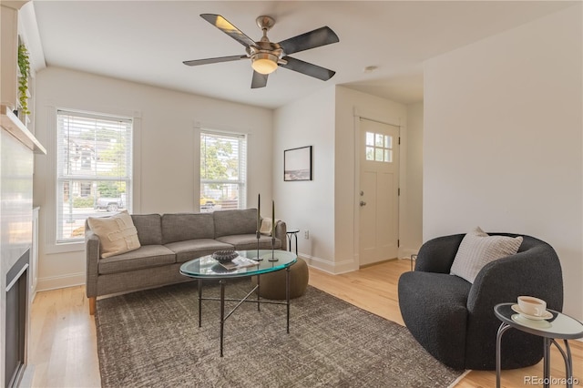 living room with ceiling fan and light hardwood / wood-style floors