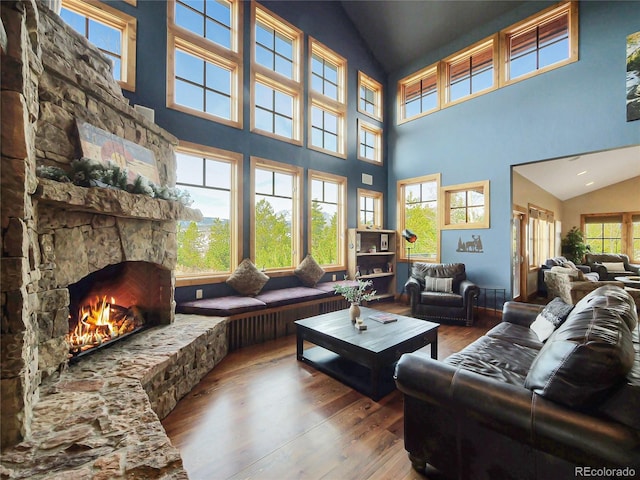 77 B Rd, Silverthorne, CO 80498 - living area featuring hardwood / wood-style flooring, high vaulted ceiling, and a stone fireplace