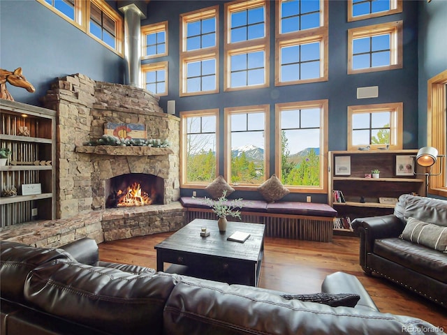 77 B Rd, Silverthorne, CO 80498 - living area with a high ceiling, hardwood / wood-style flooring, and a stone fireplace