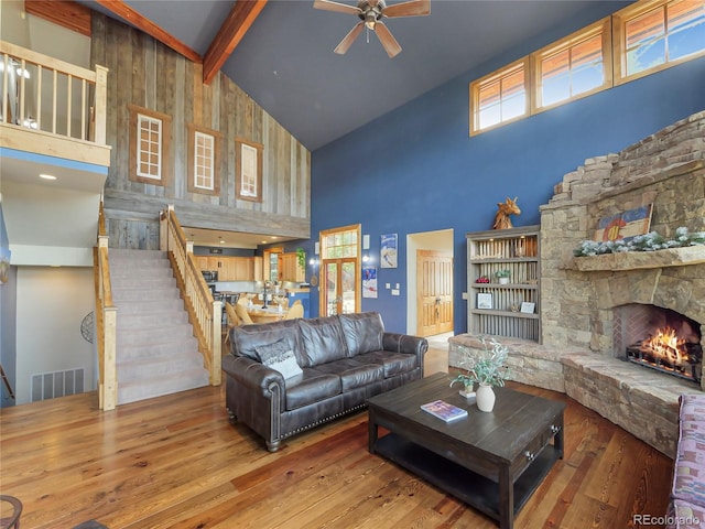 77 B Rd, Silverthorne, CO 80498 - living area with high vaulted ceiling, ceiling fan, wood-type flooring, beam ceiling, and a fireplace