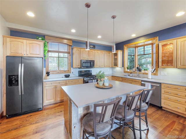 77 B Rd, Silverthorne, CO 80498 - kitchen featuring appliances with stainless steel finishes, light brown cabinets, glass insert cabinets, light countertops, and recessed lighting