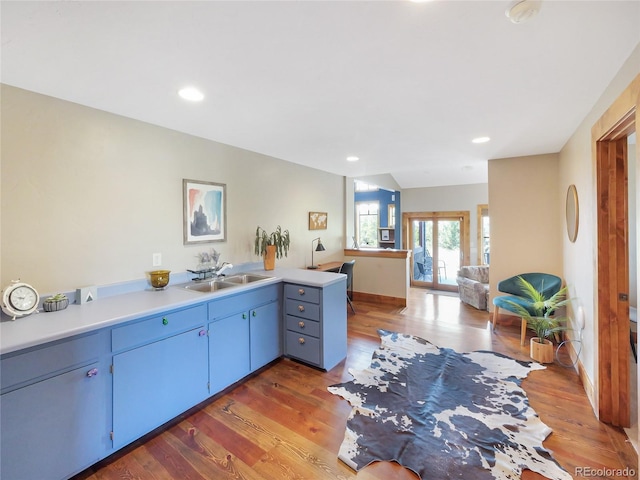 77 B Rd, Silverthorne, CO 80498 - kitchen featuring a sink, wood finished floors, blue cabinets, light countertops, and recessed lighting