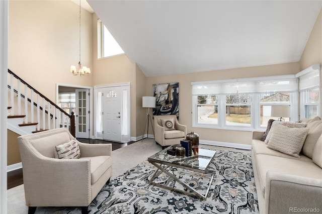 living area with an inviting chandelier, wood finished floors, high vaulted ceiling, baseboards, and stairs