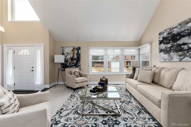 living room featuring high vaulted ceiling, baseboards, and a wealth of natural light