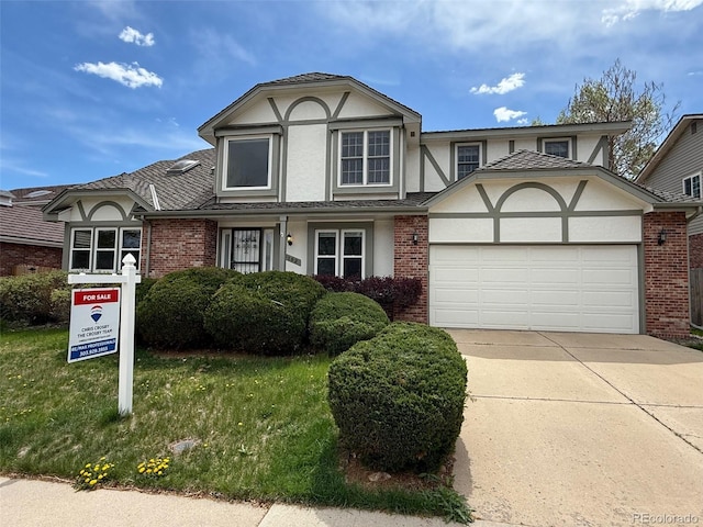 8182 Sweet Water Rd, Lone Tree, CO 80124 - tudor home with brick siding, an attached garage, stucco siding, and concrete driveway