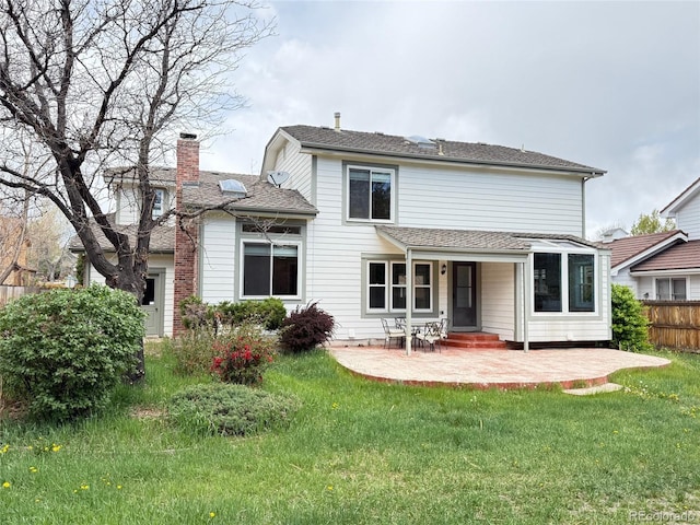 8182 Sweet Water Rd, Lone Tree, CO 80124 - back of house with fence, a patio, a chimney, a shingled roof, and a yard