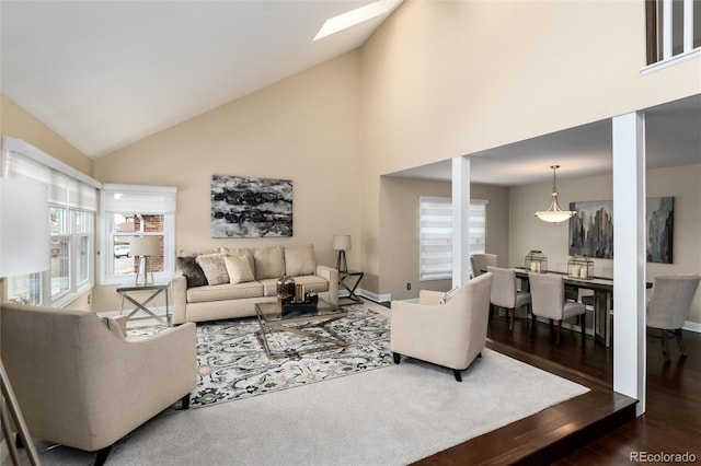 8182 Sweet Water Rd, Lone Tree, CO 80124 - living room featuring high vaulted ceiling, dark wood-style floors, a skylight, and baseboards