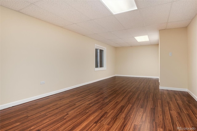 8182 Sweet Water Rd, Lone Tree, CO 80124 - empty room with dark wood-style floors, baseboards, and a paneled ceiling