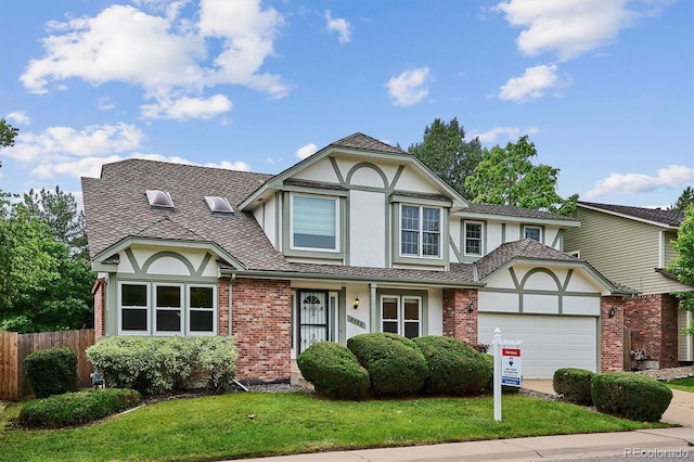 8182 Sweet Water Rd, Lone Tree, CO 80124 - tudor house featuring stucco siding, an attached garage, brick siding, and concrete driveway