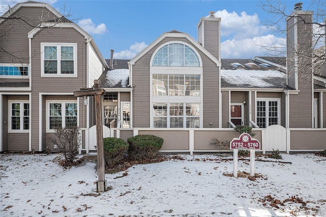 view of snow covered rear of property