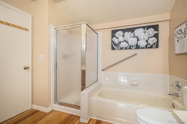 bathroom with separate shower and tub, toilet, and hardwood / wood-style floors