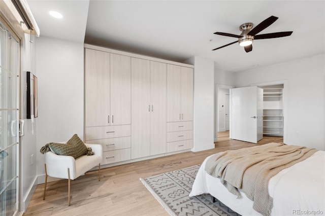 bedroom featuring ceiling fan, light wood-type flooring, and recessed lighting