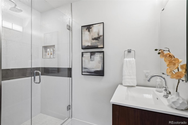 bathroom featuring a shower stall and vanity