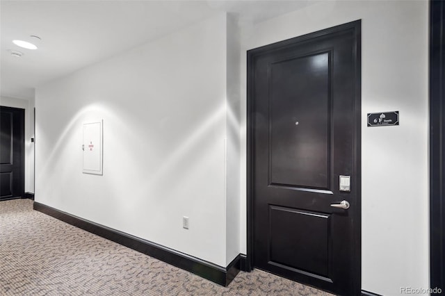 hall featuring carpet floors and baseboards