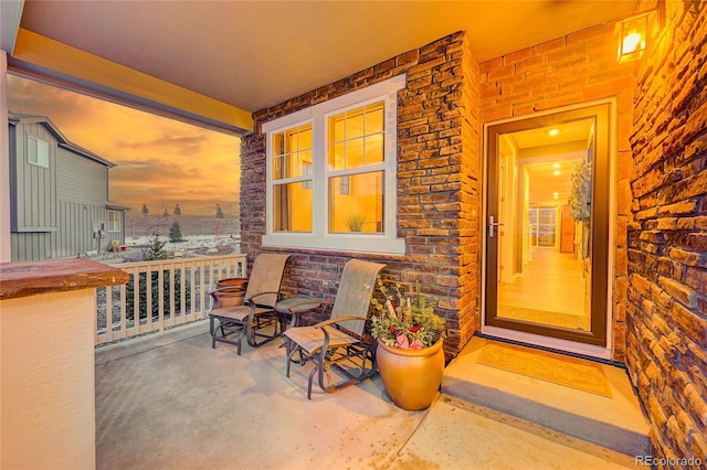 exterior entry at dusk featuring a porch