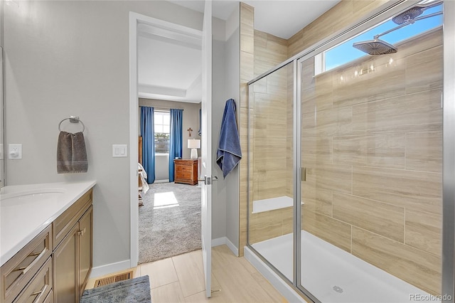 bathroom featuring vanity and a shower with shower door