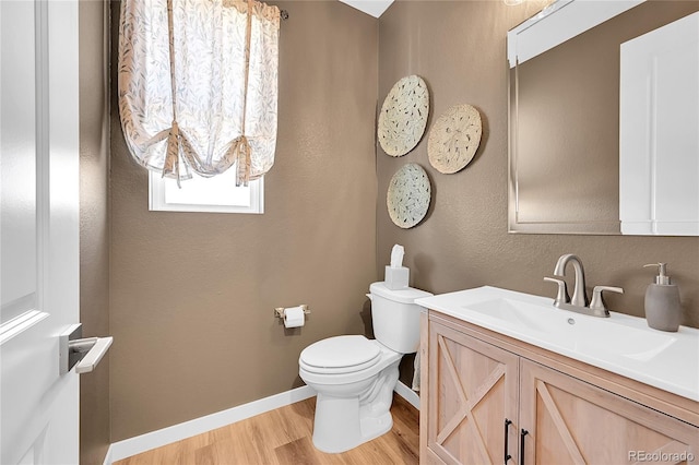 bathroom with vanity, hardwood / wood-style floors, and toilet