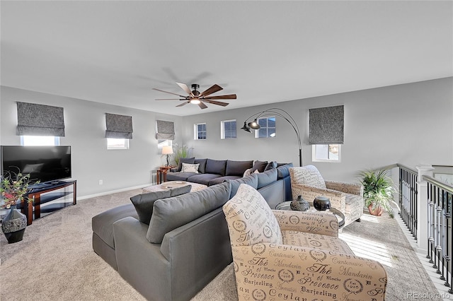 living room featuring ceiling fan, a healthy amount of sunlight, and light carpet