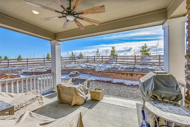 snow covered patio with ceiling fan and grilling area