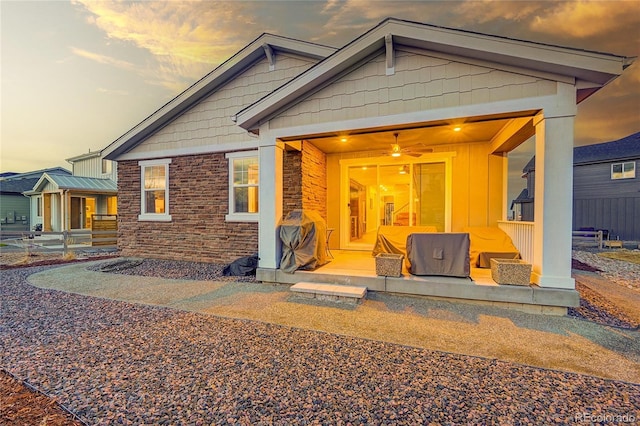 view of front of property with ceiling fan and a patio