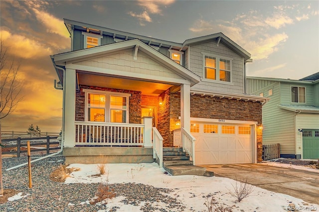 craftsman-style house featuring a garage and covered porch