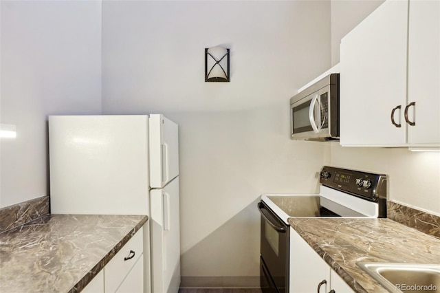 3465 S Poplar St Unit 305, Denver, CO 80224 - kitchen featuring range with electric stovetop, stainless steel microwave, freestanding refrigerator, white cabinets, and a sink