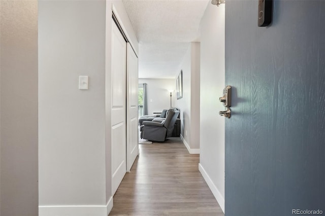 3465 S Poplar St Unit 305, Denver, CO 80224 - hallway with wood finished floors and baseboards