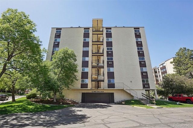 3465 S Poplar St Unit 305, Denver, CO 80224 - view of apartment building / complex with an attached garage and asphalt driveway