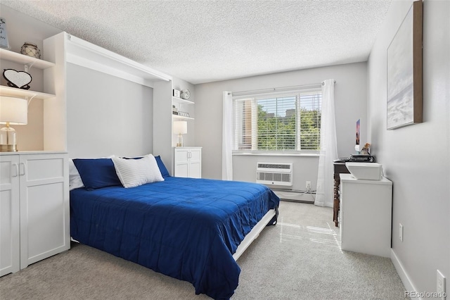 3465 S Poplar St Unit 305, Denver, CO 80224 - bedroom featuring light colored carpet, a textured ceiling, a baseboard heating unit, a wall unit AC, and baseboards