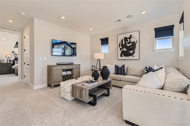 living room with light carpet and a healthy amount of sunlight