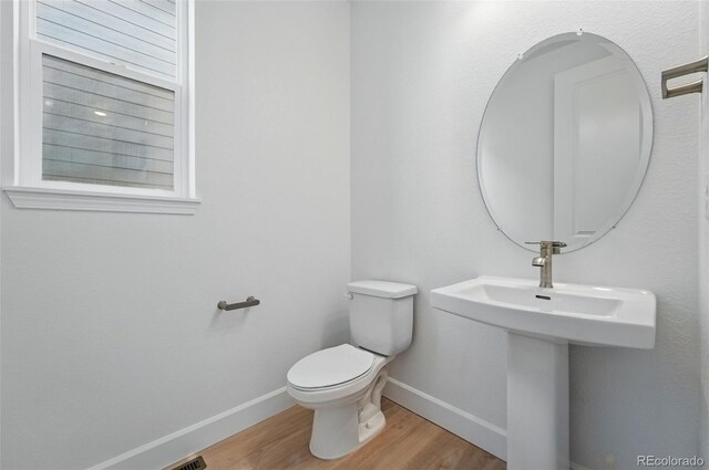 16537 Black Rose Cir, Parker, CO 80134 - bathroom with toilet, baseboards, and wood finished floors