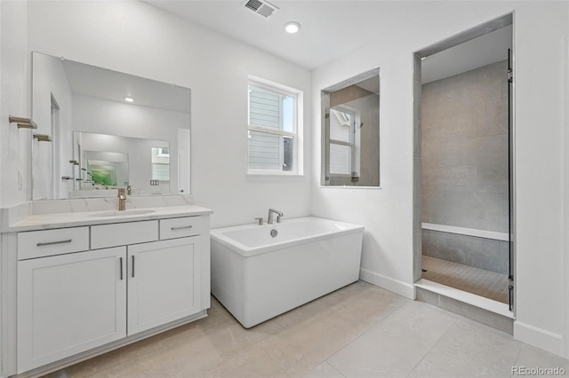 16537 Black Rose Cir, Parker, CO 80134 - full bathroom with visible vents, baseboards, a tile shower, a freestanding tub, and vanity