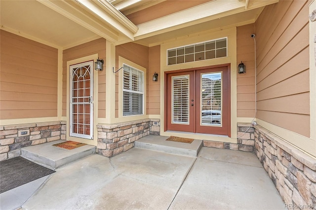 entrance to property with stone siding and french doors