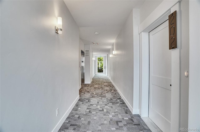 hallway with tile flooring