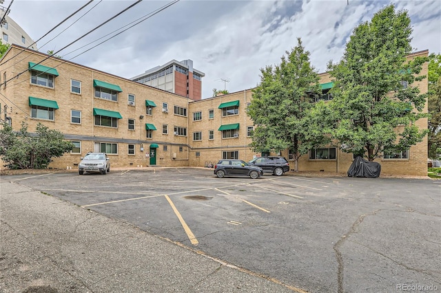 view of building exterior featuring uncovered parking