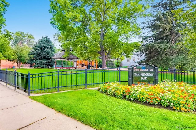 surrounding community featuring a gazebo, a yard, and fence