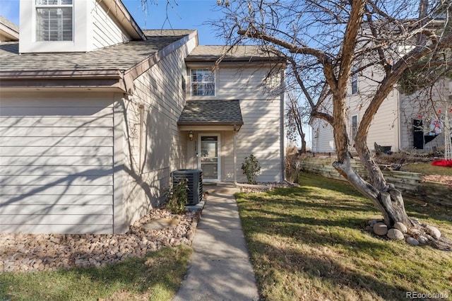 view of front of home featuring a front yard and cooling unit